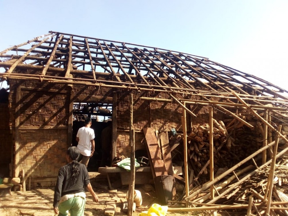 Villagers look on at the remnants of a house that was razed in a fire in Wakching village on November 8. (Morung Photo)